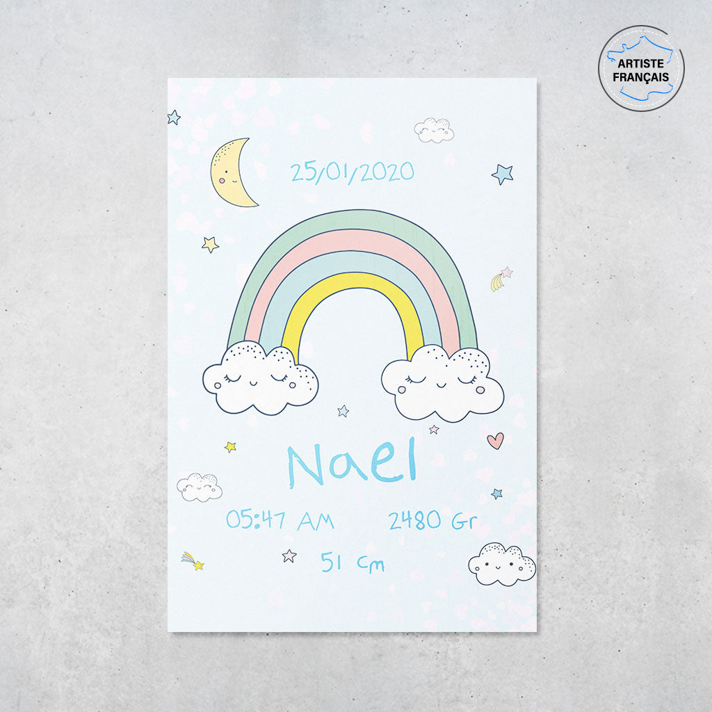 Une affiche naissance personnalisé représentant un ciel étoilé avec un arc en ciel, des étoiles et des nuages au format dessins dans des couleurs pastelles. Cette affiche est dans les tons bleus et donc pour la naissance d’un garçon. Le prénom, la date, l’heure, le poids et la taille de naissance sont personnalisables.