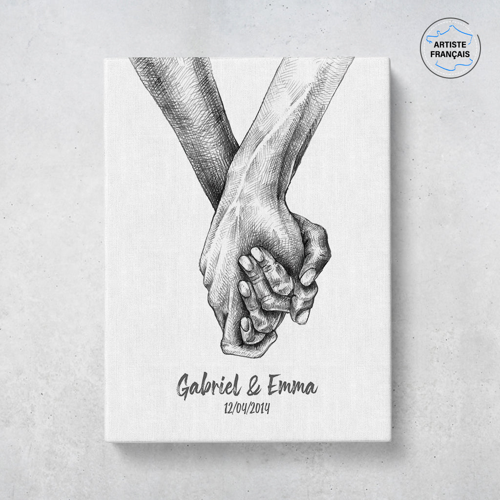 Un tableau personnalisé couple qui représente deux mains qui s’enlacent dessinées au fusain sur un fond blanc. Les prénoms et la date de rencontre du couple sont personnalisables. Le design est minimaliste.