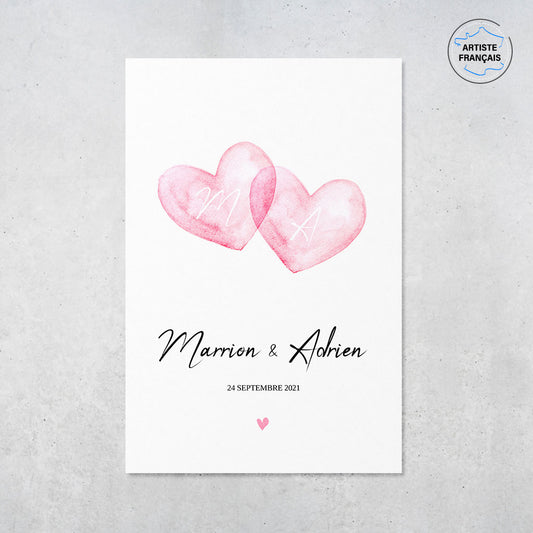 Une affiche personnalisée couple qui représente deux coeurs en aquarelle roses qui se touchent sur un fond blanc. Les prénoms et la date de rencontre du couple sont personnalisables. Le design est minimaliste. 